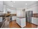 Kitchen with stainless steel appliances, center island, and breakfast bar seating at 812 Autry Oak Ct, Alpharetta, GA 30022