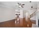 Bright living room with hardwood floors, ceiling fan, and open view into the kitchen at 812 Autry Oak Ct, Alpharetta, GA 30022