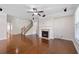 Spacious living room with hardwood floors, fireplace, ceiling fan, and staircase at 812 Autry Oak Ct, Alpharetta, GA 30022