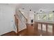 Open living room with hardwood floors, fireplace, large windows, and staircase at 812 Autry Oak Ct, Alpharetta, GA 30022