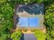 Aerial view of multi-sport courts, featuring tennis and basketball, surrounded by trees and parking at 1552 Brentwood Dr, Marietta, GA 30062