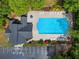 Aerial view of community pool and clubhouse with lounge chairs and trees surrounded by convenient parking at 1552 Brentwood Dr, Marietta, GA 30062