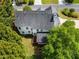 Aerial view of home, backyard with deck and screened-in porch and mature trees at 1552 Brentwood Dr, Marietta, GA 30062