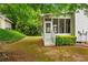 Backyard featuring a screened-in porch, a well-manicured lawn, and mature landscaping at 1552 Brentwood Dr, Marietta, GA 30062