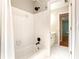 Bathroom featuring modern showerhead, and white tiling at 1552 Brentwood Dr, Marietta, GA 30062