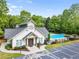 Clubhouse with large community pool in the background and convenient parking spaces at 1552 Brentwood Dr, Marietta, GA 30062