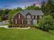Charming two-story brick home with a well-manicured lawn and mature landscaping at 1552 Brentwood Dr, Marietta, GA 30062