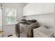 Bright laundry room with modern washer, dryer, and utility sink at 1552 Brentwood Dr, Marietta, GA 30062