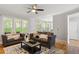Inviting living room with ample seating, a ceiling fan and a view to the dining area and kitchen at 1552 Brentwood Dr, Marietta, GA 30062