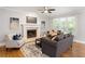 Comfortable living room offers a fireplace, hardwood floors, and natural light through the large windows at 1552 Brentwood Dr, Marietta, GA 30062