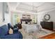 Bedroom with a tray ceiling, hardwood floors, decorative art and comfortable seating at 1552 Brentwood Dr, Marietta, GA 30062