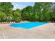 Community pool with lounge chairs and lush trees; a perfect spot to relax and enjoy the outdoors at 1552 Brentwood Dr, Marietta, GA 30062