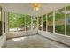 Screened-in porch with tile floors, ceiling fan, and views of the backyard at 1552 Brentwood Dr, Marietta, GA 30062