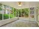 Screened-in porch with tile floors, ceiling fan, and views of the backyard and wood deck at 1552 Brentwood Dr, Marietta, GA 30062