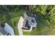 Aerial view of a home with a dark roof, expansive yard and a long driveway at 1895 Henley Way, Alpharetta, GA 30009