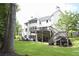A large backyard with a spacious deck, lush grass, and mature trees that provide ample shade at 1895 Henley Way, Alpharetta, GA 30009