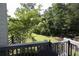 Backyard view from the deck showcasing a lush green lawn and mature trees, providing a serene setting at 1895 Henley Way, Alpharetta, GA 30009