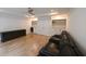 Finished basement with a ceiling fan, luxury vinyl flooring, a wet bar, and a comfortable black leather couch at 1895 Henley Way, Alpharetta, GA 30009