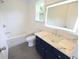 Bathroom featuring a combination bathtub and shower, marble sink, and a vanity with navy cabinets at 1895 Henley Way, Alpharetta, GA 30009