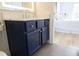 A stylish navy bathroom vanity with silver hardware and a marble countertop at 1895 Henley Way, Alpharetta, GA 30009