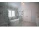 Modern bathroom with a freestanding tub, glass shower, dual-entry shower, and a double vanity at 1895 Henley Way, Alpharetta, GA 30009