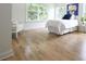 Bedroom featuring hardwood floors, a bright window, and a light color scheme at 1895 Henley Way, Alpharetta, GA 30009