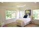 This bedroom features a large window with leafy trees outside, providing natural light at 1895 Henley Way, Alpharetta, GA 30009