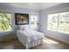 Bright bedroom features two large windows with natural light and a lovely art piece at 1895 Henley Way, Alpharetta, GA 30009