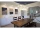 Elegant dining room boasting a modern chandelier, ample built-in storage, and a staircase leading to upper level at 1895 Henley Way, Alpharetta, GA 30009