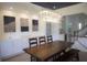 Dining room features a modern chandelier, stylish artwork, and built-in cabinets at 1895 Henley Way, Alpharetta, GA 30009