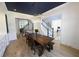 Dining area with a long wooden table, stylish light fixture, and hardwood floors at 1895 Henley Way, Alpharetta, GA 30009