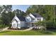 Elegant two-story home with a well-manicured lawn, showcasing classic architectural details and mature trees at 1895 Henley Way, Alpharetta, GA 30009