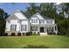 Beautiful two-story home features a manicured lawn, blue shutters, and a covered front porch with stately pillars at 1895 Henley Way, Alpharetta, GA 30009