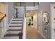 Bright foyer features hardwood floors, a staircase with white risers, and an elegant gold mirror at 1895 Henley Way, Alpharetta, GA 30009