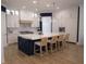 Modern kitchen featuring white cabinetry, a large island with bar seating, and stainless steel appliances at 1895 Henley Way, Alpharetta, GA 30009