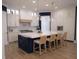 Modern kitchen boasts an island with bar seating, white cabinets, and stainless steel appliances at 1895 Henley Way, Alpharetta, GA 30009