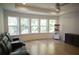 Home movie room features a large window, wood floors, and comfortable seating, perfect for entertainment at 1895 Henley Way, Alpharetta, GA 30009
