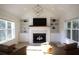 Bright living room boasts built-in shelves and modern fireplace, complete with elegant chandelier lighting at 1895 Henley Way, Alpharetta, GA 30009