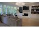 Bright living room features a stylish fireplace, custom built-ins, recessed lighting, and a wall of windows at 1895 Henley Way, Alpharetta, GA 30009
