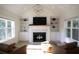 Bright living room with a vaulted ceiling, fireplace, built-in shelves and large windows at 1895 Henley Way, Alpharetta, GA 30009