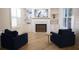 Bright living room features hardwood floors, built-in shelving, and a fireplace with decorative accents at 1895 Henley Way, Alpharetta, GA 30009