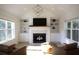 Bright and airy living room with a fireplace, built-in shelving, and comfortable seating at 1895 Henley Way, Alpharetta, GA 30009