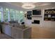 Sun-filled living room with large windows, a fireplace, built-in shelves, and comfortable seating at 1895 Henley Way, Alpharetta, GA 30009