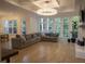 Spacious living room with a modern chandelier, large windows offering natural light, and comfortable seating area at 1895 Henley Way, Alpharetta, GA 30009