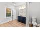 Bathroom features a double sink vanity, oval mirrors, and a window bringing in lots of natural light at 2128 Hosea L Williams Ne Dr, Atlanta, GA 30317