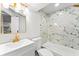Beautiful bathroom featuring a white vanity, stylish gold fixtures, and marble-look tile in the shower at 2128 Hosea L Williams Ne Dr, Atlanta, GA 30317
