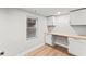 Bright office space with white cabinets, light wood countertop and flooring, and a window for natural light at 2128 Hosea L Williams Ne Dr, Atlanta, GA 30317