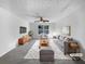 Bright living room features stylish furniture, a ceiling fan, and natural light from a large window at 3217 Fairington Dr, Lithonia, GA 30038