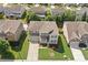 Aerial view of two-story home with well-manicured lawn, mature trees, and long driveway at 522 Spring View Dr, Woodstock, GA 30188