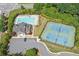 Aerial view of the community pool, clubhouse, and tennis courts in a well-maintained neighborhood at 522 Spring View Dr, Woodstock, GA 30188